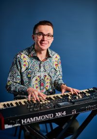 Young man plays a keyboard